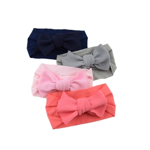 Set of 4 soft nylon baby headbands with large bows in navy, grey, pink and red colors