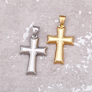 Gold and silver polished stainless steel Ankh cross pendants on marble background