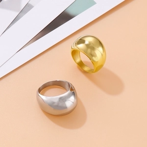 Polished gold and silver dome rings in minimalist stainless steel, diagonal view