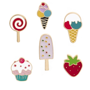 Macro shot of 6 cute enamel pins featuring colorful strawberry and ice cream treats