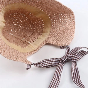 Detail of straw hat interior showing beige cotton sweatband and adjustable drawstring