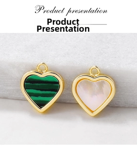 Macro detail of heart pendants featuring malachite and mother of pearl in gold frames