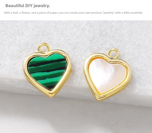 Macro detail of heart-shaped malachite and mother of pearl jewelry pendants with gold trim