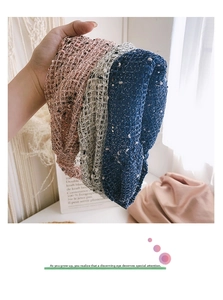 Detail of knitted lace headbands in pink and blue with colorful dotted yarn texture