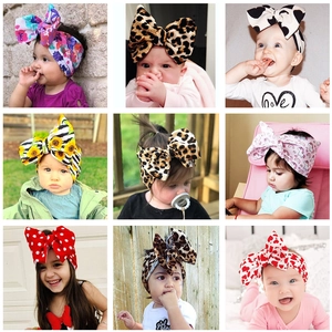 Baby headband collection with large bows in various patterns like floral, leopard, and hearts