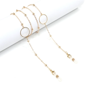 Close-up of gold geometric eyewear chain with decorative beads and anti-slip rings