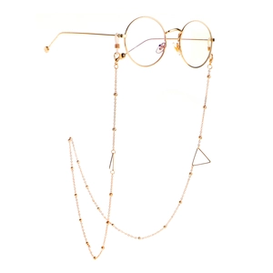 Detail view of golden geometric bead glasses chain with hollow triangle charms on eyewear