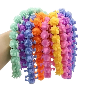Colorful TPR caterpillar fidget toys with soft spikes shown in a group for sensory play