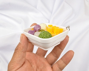 Close-up of miniature dessert keychain with colorful taro balls in a white square bowl