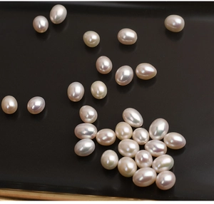 Close-up of high luster 7.5-8mm oval white freshwater pearls for DIY jewelry making