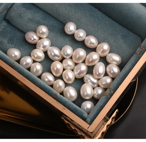 Macro shot of high-luster 7.5-8mm natural freshwater pearls in a blue velvet jewelry box