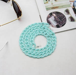 Detail of mint green acrylic eyeglass chain with silicone anti-slip loops on white background