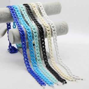 Acrylic chunky glasses chains in multiple colors on a grey velvet jewelry display