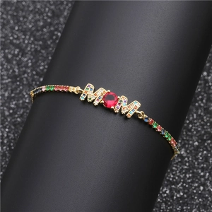Adjustable gold MOM bracelet with colorful zircon stones on a jewelry display stand