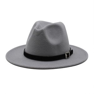 Detailed view of grey wool felt fedora with black belt buckle trim on white background