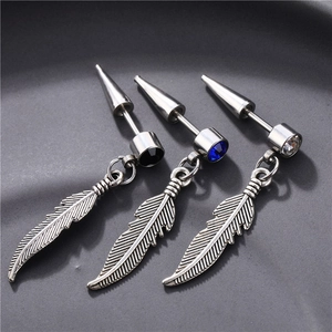 Macro detail of gothic wing earrings with black, blue, and clear zircon stone settings
