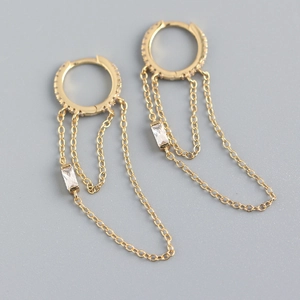 Detail of gold chain tassel earrings with cubic zirconia and sparkling pave crystals