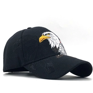 Detailed close-up of eagle head embroidery on a black cotton twill baseball cap