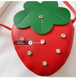 Close-up of strawberry purse with red lychee texture leather and sparkling rhinestones