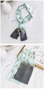 Detail of blue floral silk scarf with grey contrast tips on elegant white background