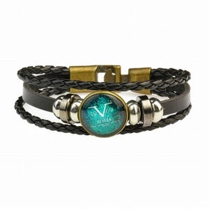 Detail of multi-layer black braided leather bracelet with vintage bronze logo buckle