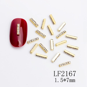 Detail view of LF2167 1.5x7mm golden rectangular nail art charms with tiny white rhinestones