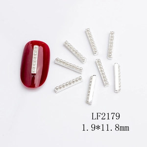 Detail of silver nail art metal bars with small white pearls for manicure decoration