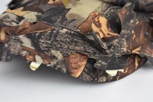 Close-up of 3D leaf camo fabric with jagged edges and detailed stitching for hunting hats