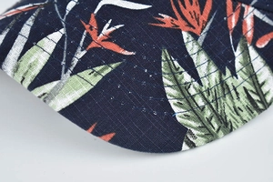 Close-up of navy blue sun hat brim with tropical floral print and reinforced stitching