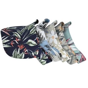 Women's sun visor hats in five tropical floral patterns with woven fabric texture