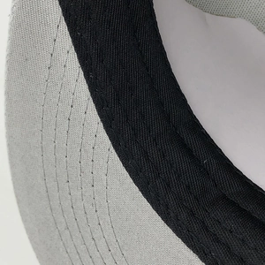 Close-up of grey stitching on peak and black sweatband of hip-hop baseball cap