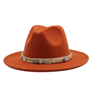 Orange wool fedora hat with ethnic woven band and metal scorpion decorative plaque