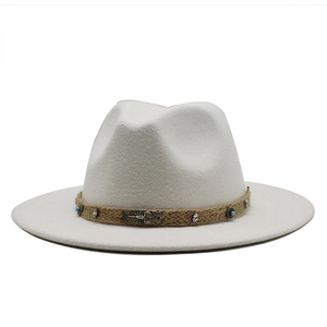 Detailed shot of white wool fedora hat with woven cord and scorpion metal charm