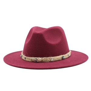 Detail of burgundy wool fedora featuring braided band with turquoise and vintage metal studs