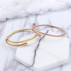 Adjustable woven stainless steel wire bracelets in gold and rose gold finishes