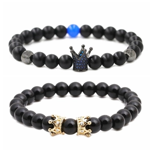 Set of two black beaded bracelets with gold and black crowns featuring blue rhinestones