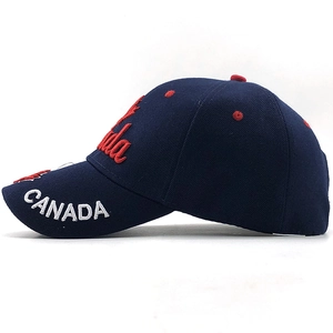 Detail of embroidered Canada logo and red maple leaf on navy blue baseball cap