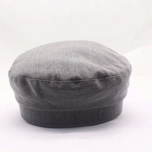 Detailed front view of dark grey rhinestone newsboy cap with denim twill texture