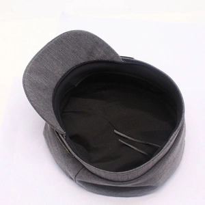 Detail view of dark grey newsboy hat featuring inner lining and adjustable drawstring