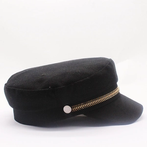 Elegant black baker boy hat with golden metal chain detail on a white background