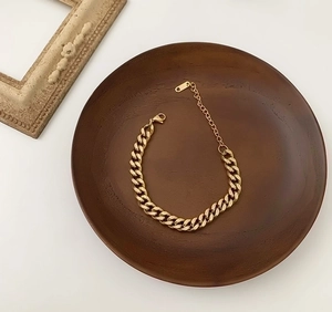 Chic 18K gold plated stainless steel chunky curb chain bracelet on a vintage wood tray