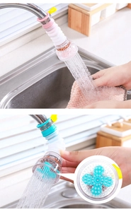 Detail of pink and cyan faucet filter with flexible rotating tube and mineral stones
