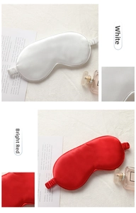 Detailed view of white and red silk sleep masks showing smooth fabric and elastic bands