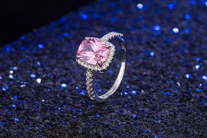 Close-up of S925 silver ring featuring pink cushion-cut center stone and side accents