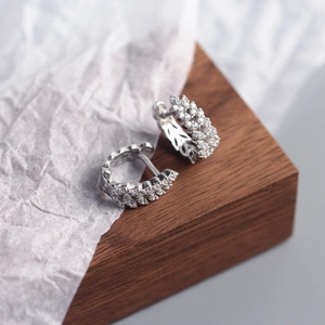 Macro shot of silver S925 sterling silver hoop earrings with marquise-cut crystals