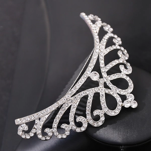 Detailed view of silver rhinestone tiara hair comb with hollow crown pattern