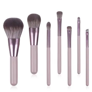 Detailed view of 7 professional makeup brushes with rose-colored handles and purple ferrules