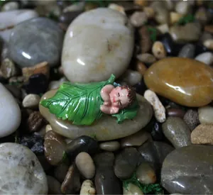 Detail of baby sleeping in green leaf resin figurine for succulent garden micro landscape