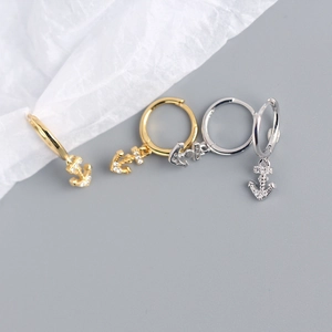 Detail of S925 sterling silver anchor earrings in gold and silver finish with S925 stamp