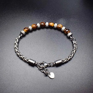 Detail of 6mm tiger eye bead bracelet with silver stainless steel chain and lobster clasp